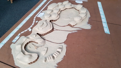 The inner gardens are divided into three main zones. The inner garden of the school with an amphitheater and a playground for the first grade (in the background). Herb and vegetable garden (in the middle) and inner garden of the kindergarten (in the foreground on the left). These three main zones have different moods and will be divided by paths, terrain ridges, garden elements and greenery.